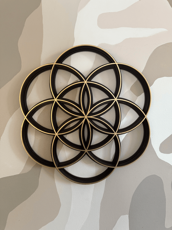 Decorative wall art of the Seed of Life on a neutral camouflage background
